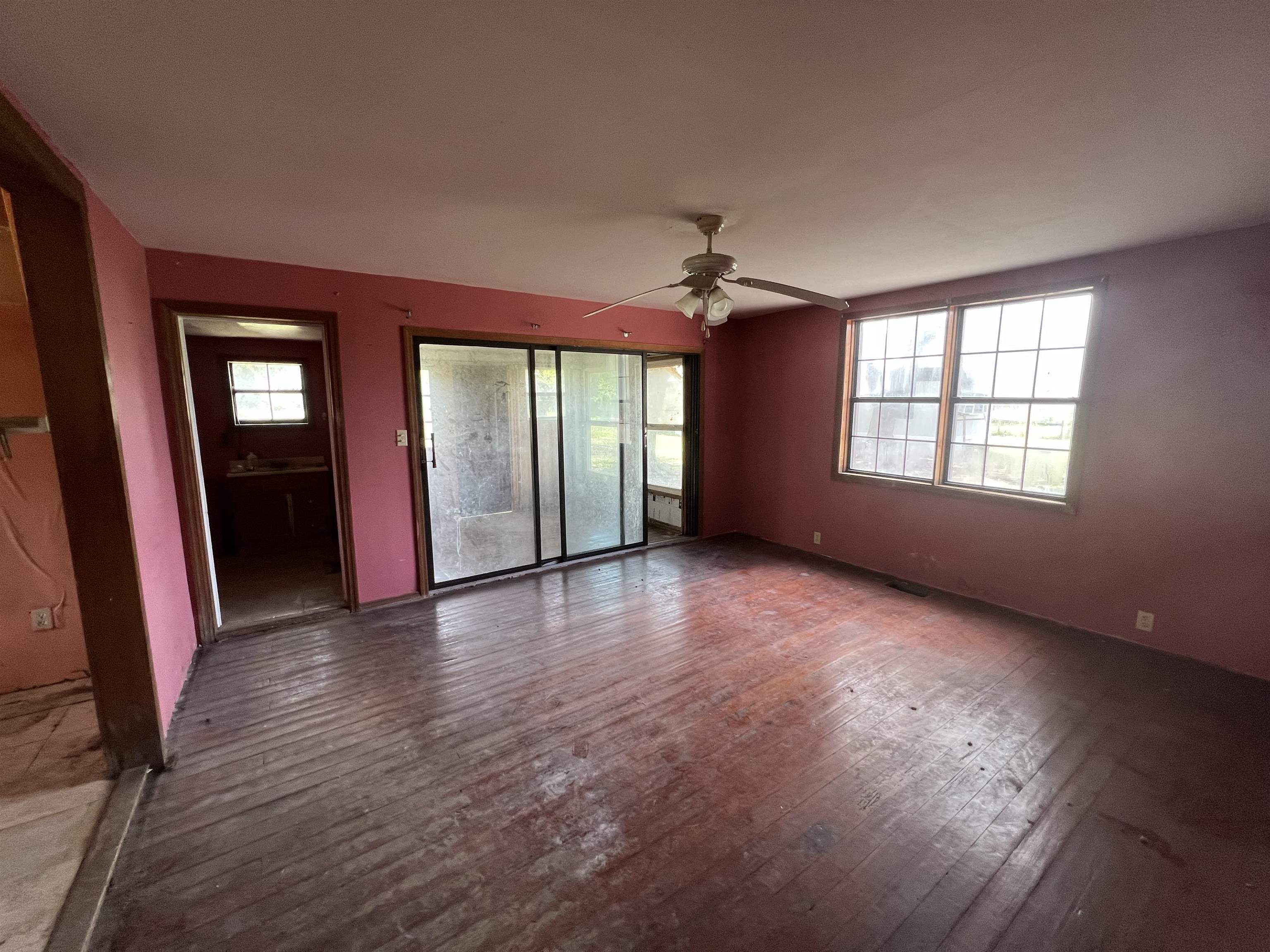 9680 Luther Beck Road Hastings, FL 32145 - Photo 14 of 24 an empty room with wooden floor and windows