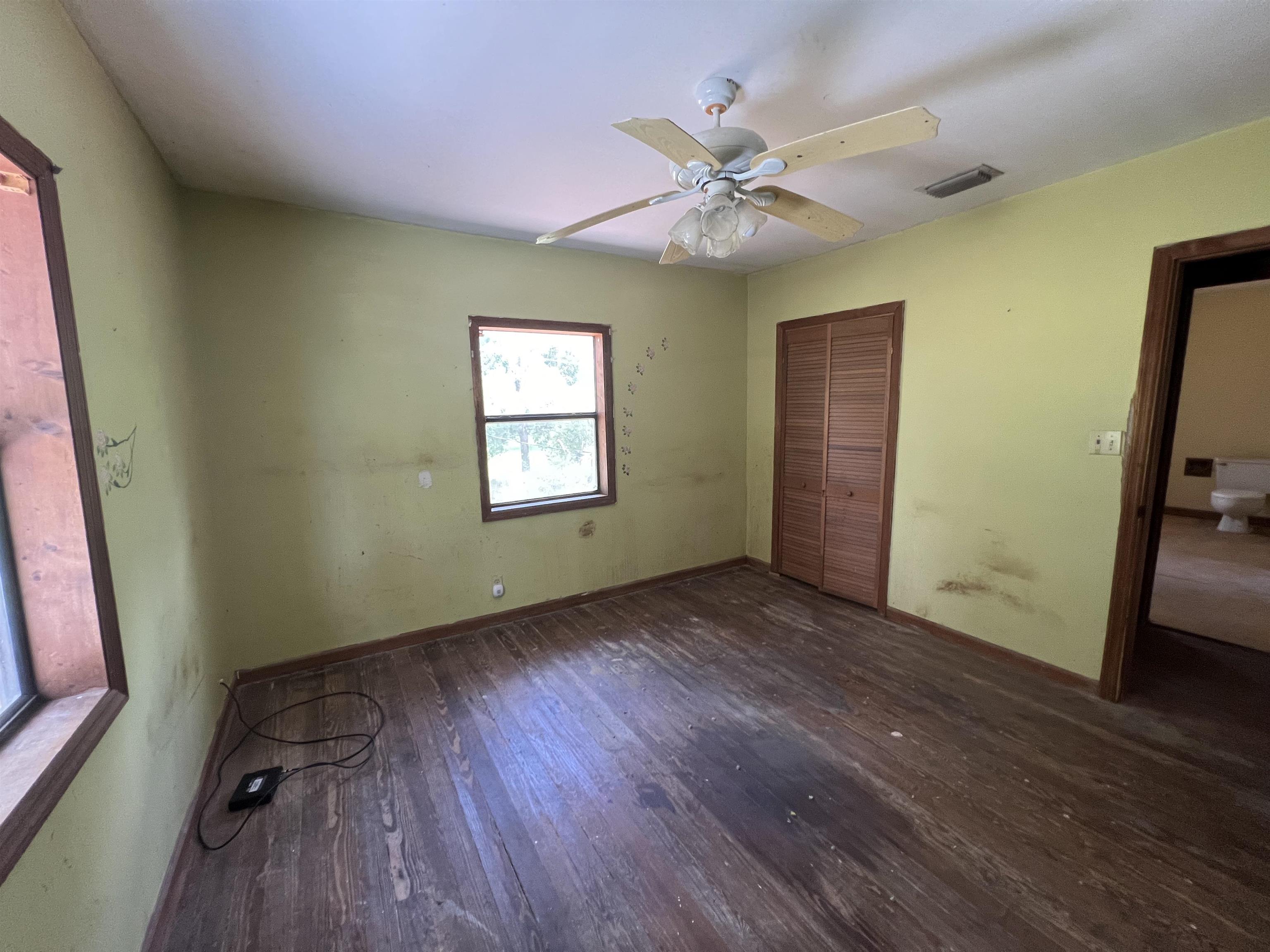 9680 Luther Beck Road Hastings, FL 32145 - Photo 23 of 24 a view of an empty room with wooden floor and a window