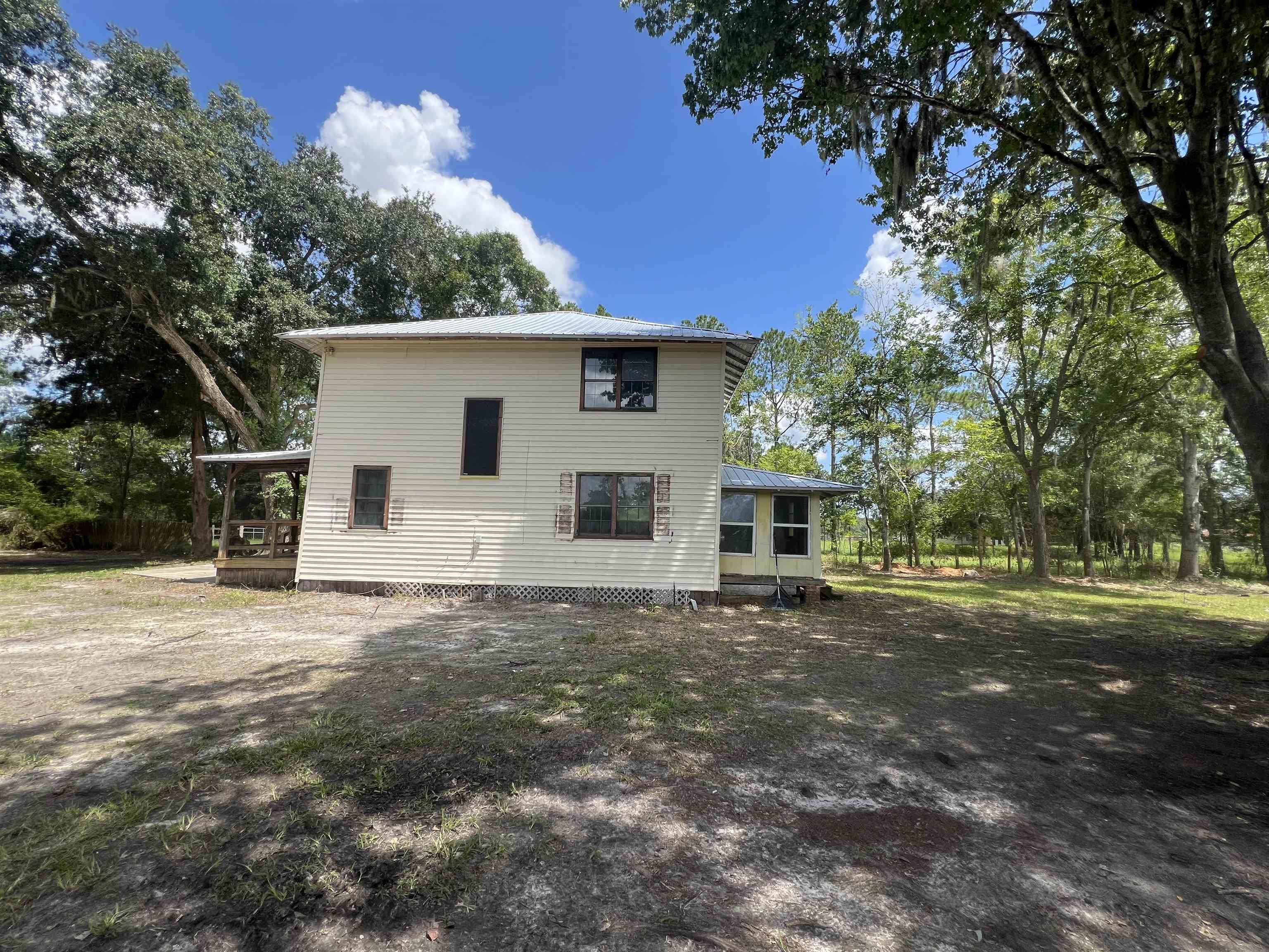 9680 Luther Beck Road Hastings, FL 32145 - Photo 8 of 24 a house with trees in the background
