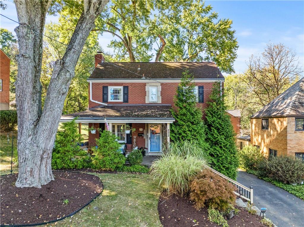a front view of a house with a garden