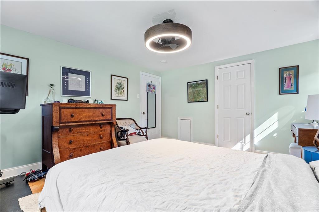 552 Audubon Avenue Pittsburgh, PA 15228 - Photo 15 of 30 a bedroom with a bed and a chandelier