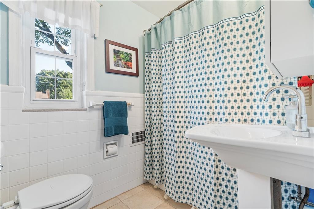 552 Audubon Avenue Pittsburgh, PA 15228 - Photo 17 of 30 a bathroom with a sink a toilet and shower curtain