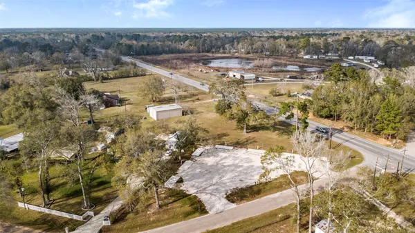 a view of a yard with wooden fence