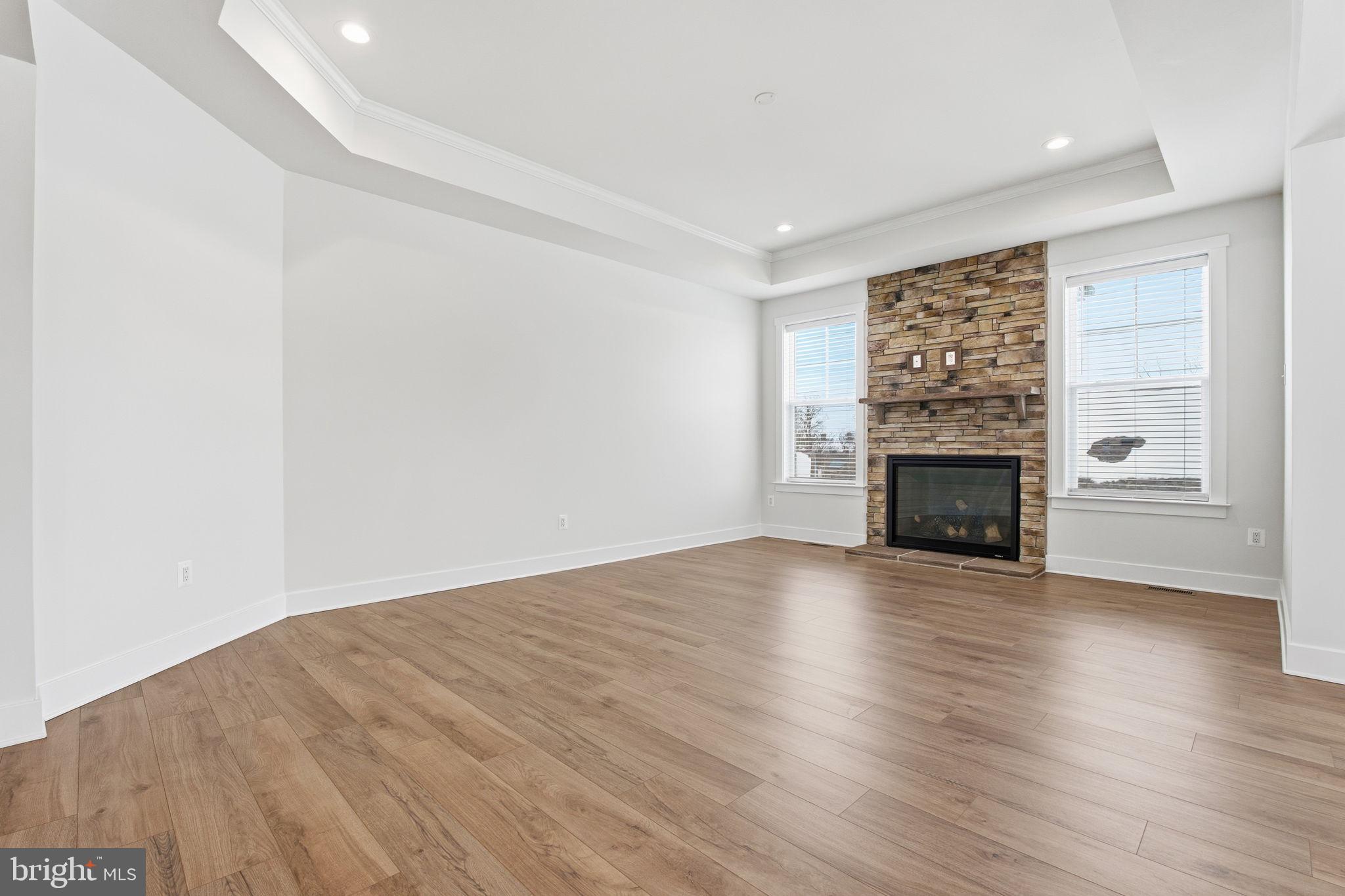 126 Bridge Valley Road Gettysburg, PA 17325 - Photo 3 of 36 an empty room with wooden floor fireplace and windows