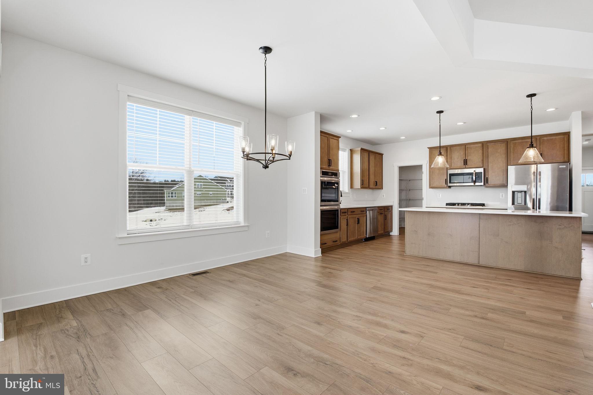 126 Bridge Valley Road Gettysburg, PA 17325 - Photo 6 of 36 a large kitchen with stainless steel appliances kitchen island a large counter top and a wooden floors
