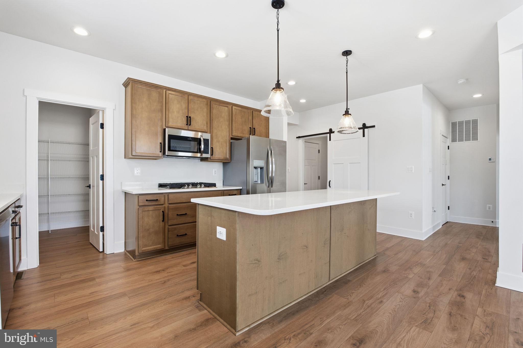126 Bridge Valley Road Gettysburg, PA 17325 - Photo 9 of 36 a kitchen with kitchen island a sink stainless steel appliances and cabinets