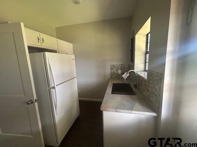 11510 Kitty Hawk Frankston, TX 75763 - Photo 20 of 26 a kitchen with a refrigerator and wooden floor