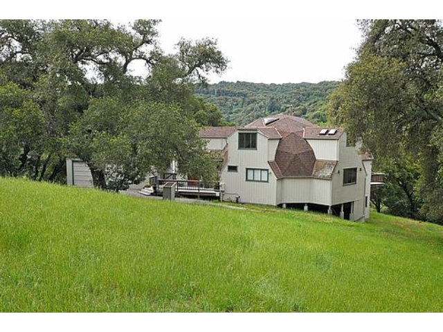 a view of a house with a backyard porch and sitting area