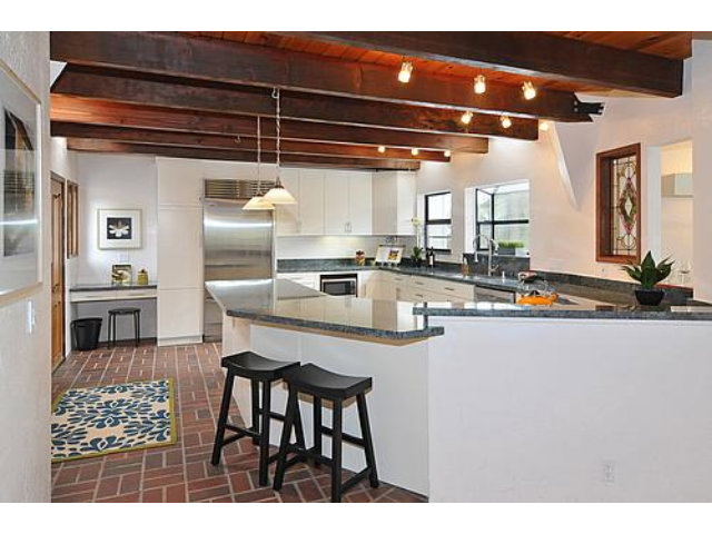 3895 Page Mill Road Los Altos, CA 94022 - Photo 7 of 15 a kitchen with stainless steel appliances kitchen island granite countertop a table and chairs in it