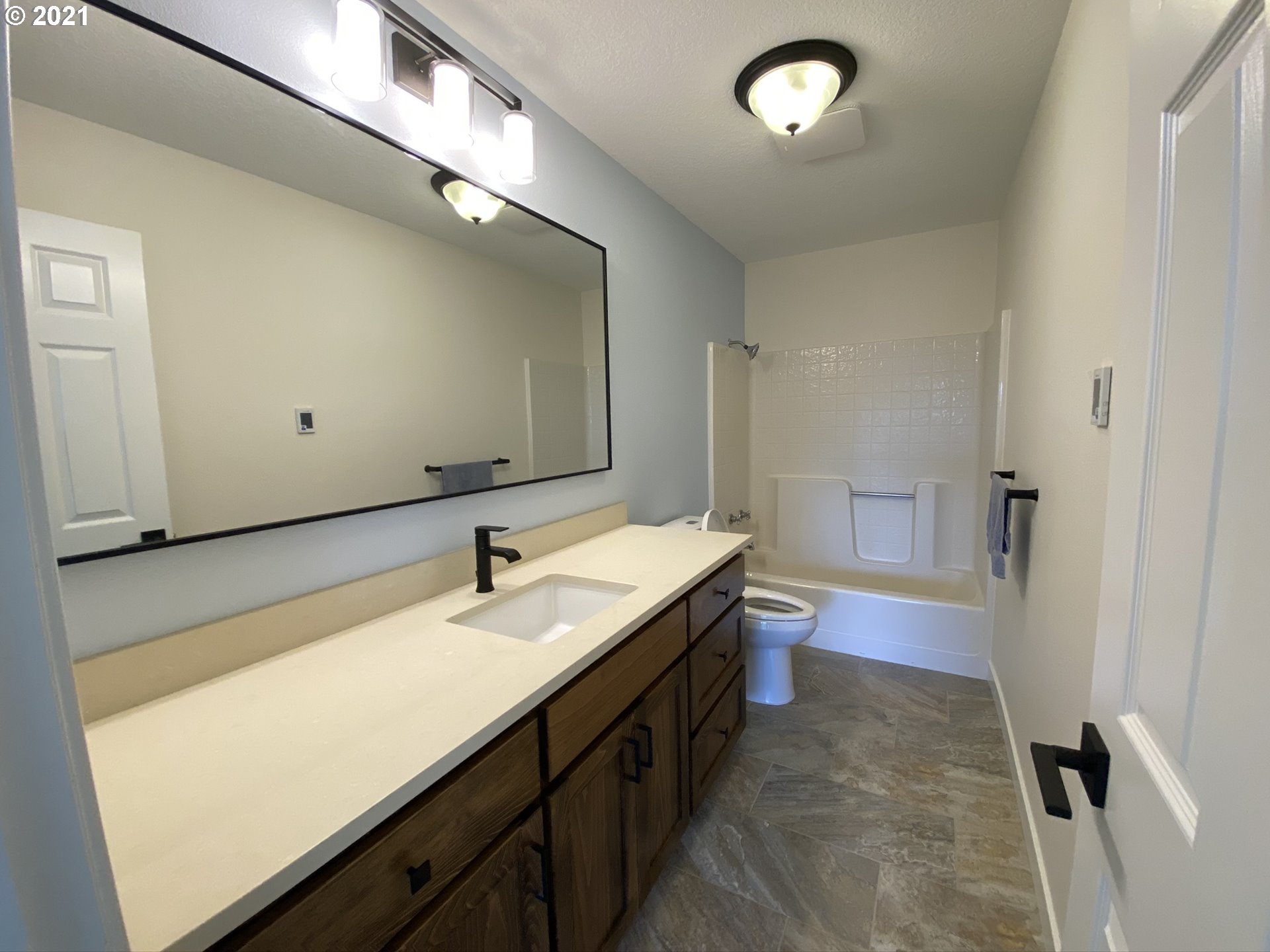 8900 Southeast Alder Ridge Road Damascus, OR 97089 - Photo 14 of 32 a bathroom with a sink and a mirror