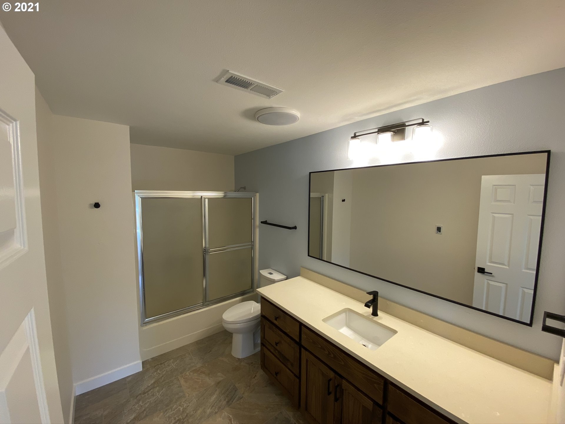 8900 Southeast Alder Ridge Road Damascus, OR 97089 - Photo 19 of 32 a bathroom with a double vanity sink mirror and toilet