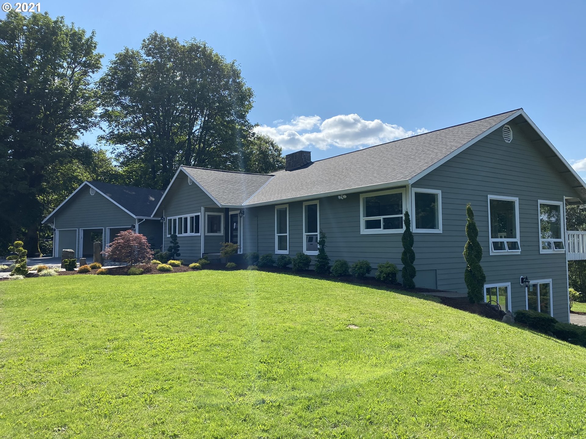 8900 Southeast Alder Ridge Road Damascus, OR 97089 - Photo 2 of 32 a front view of a house with a yard
