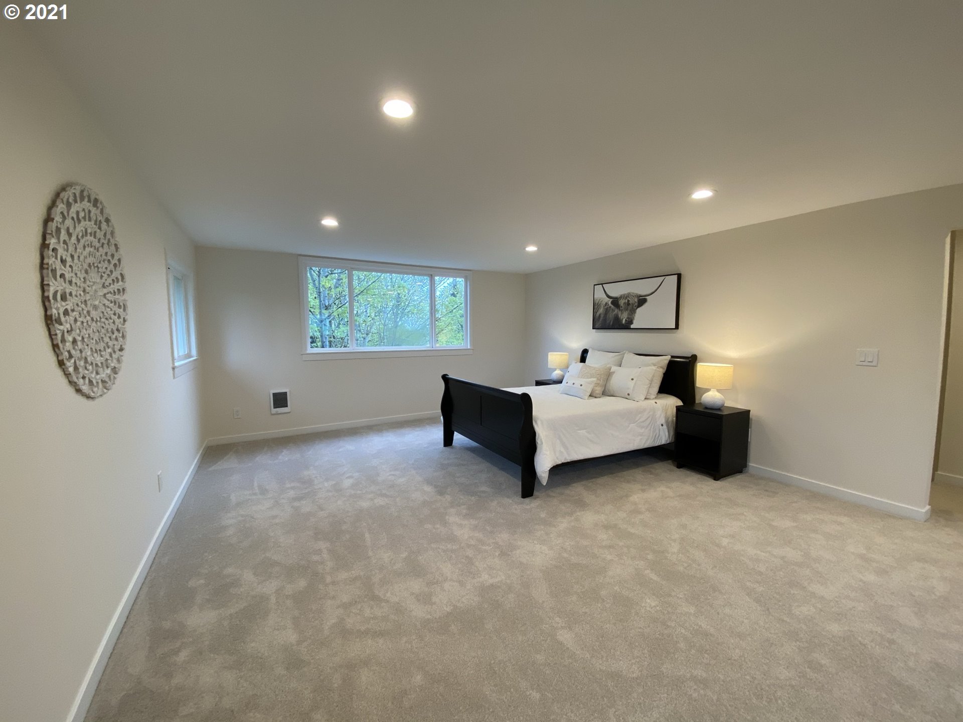 8900 Southeast Alder Ridge Road Damascus, OR 97089 - Photo 26 of 32 a spacious bedroom with a bed and a large window