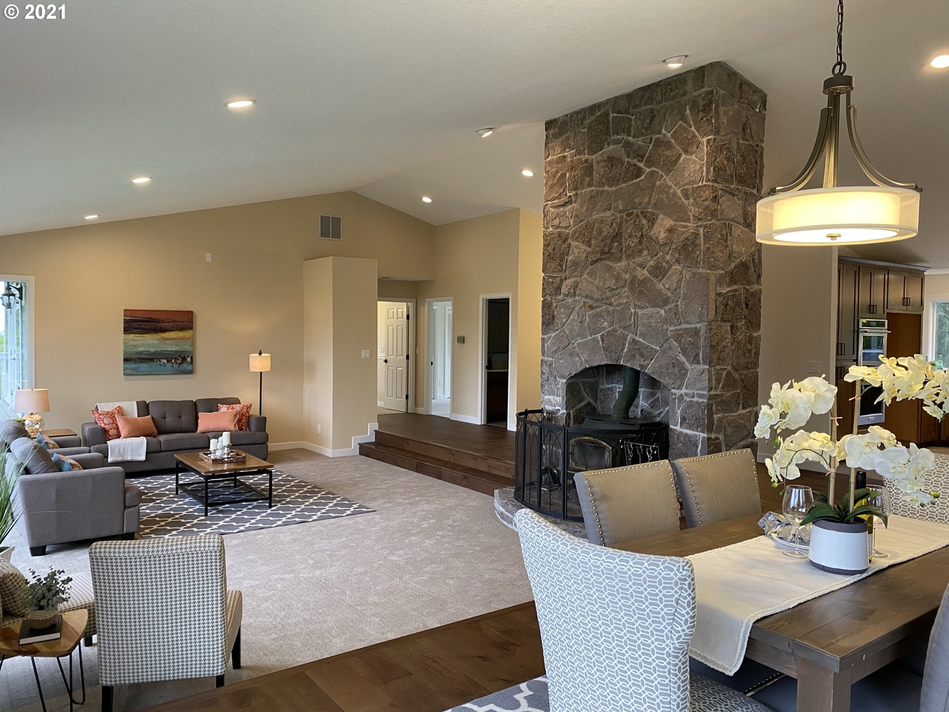 8900 Southeast Alder Ridge Road Damascus, OR 97089 - Photo 5 of 32 a living room with furniture a fireplace and a table