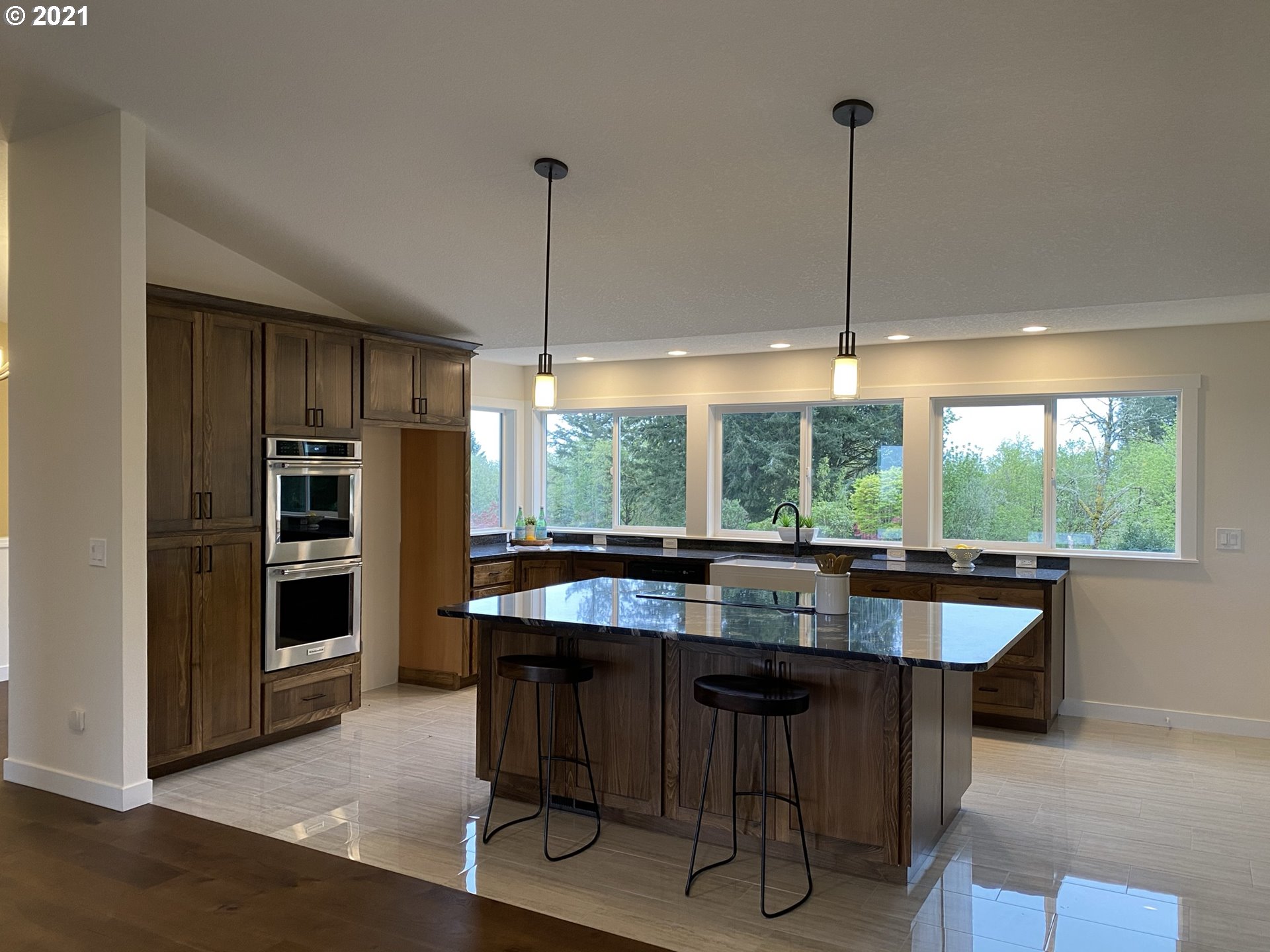 8900 Southeast Alder Ridge Road Damascus, OR 97089 - Photo 7 of 32 a kitchen with a sink a counter and chairs