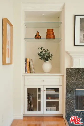 a living room with a fireplace and painting on the wall
