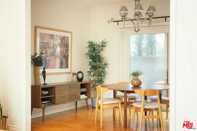 a view of a dining room with furniture and chandelier