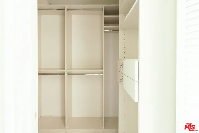 a bathroom with a granite countertop sink toilet and mirror