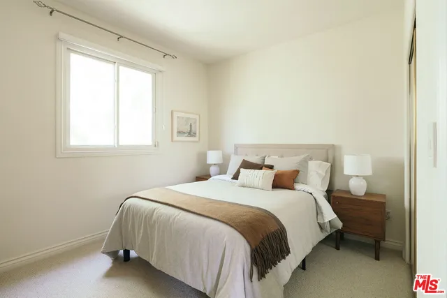 a bedroom with a bed and a television