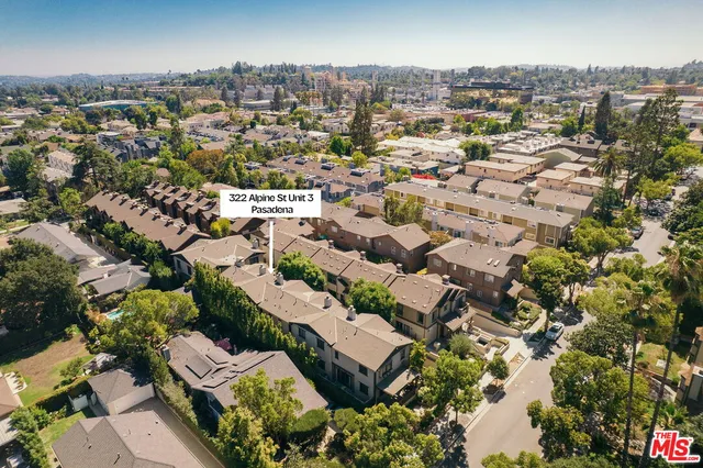 an aerial view of residential houses with outdoor space