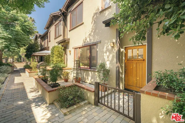 a view of a house with a chairs and wooden fence