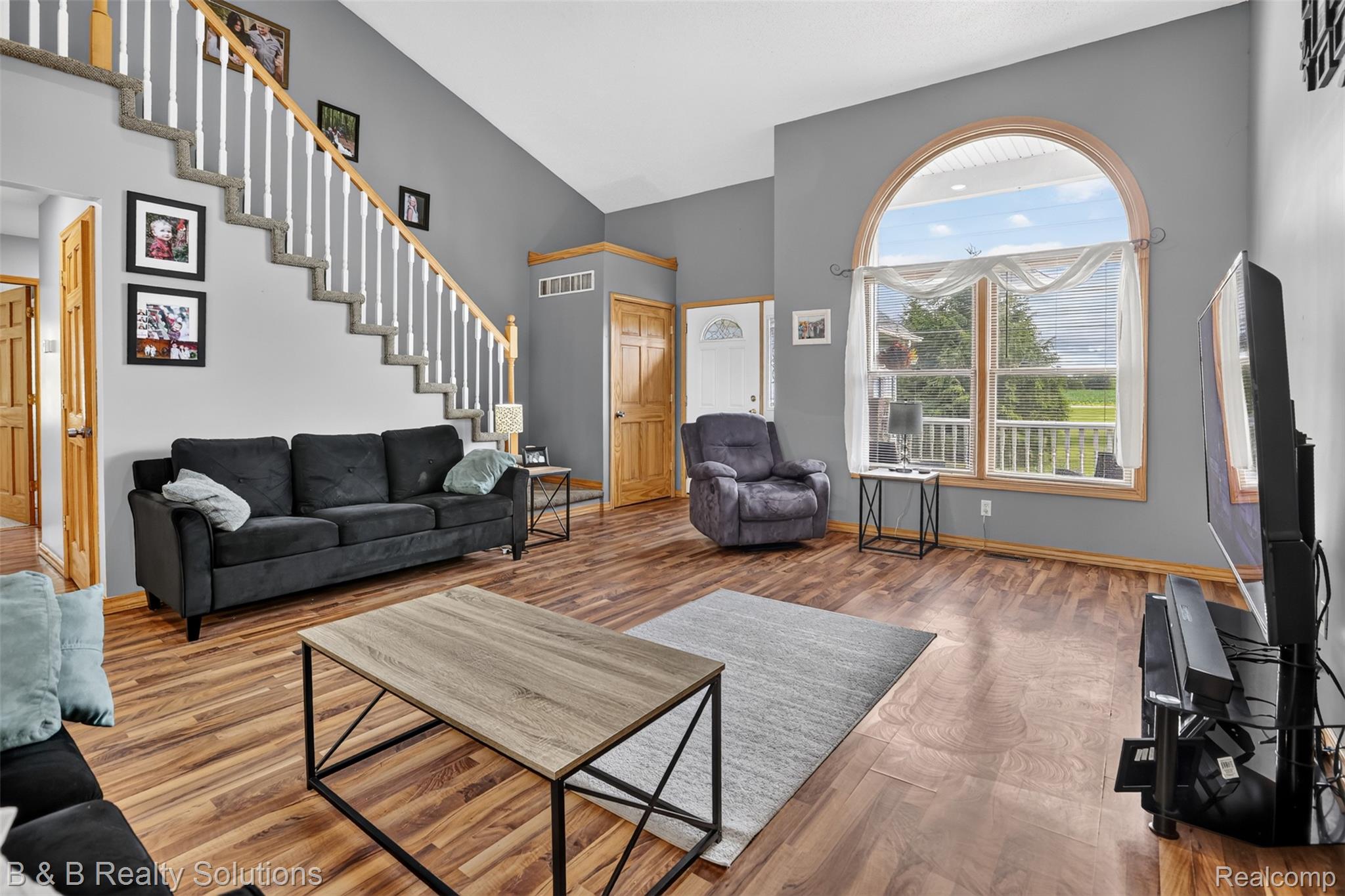 3097 East Burnside Road North Branch, MI 48461 - Photo 6 of 52 Spacious living area featuring a vaulted ceiling and wood-finish flooring