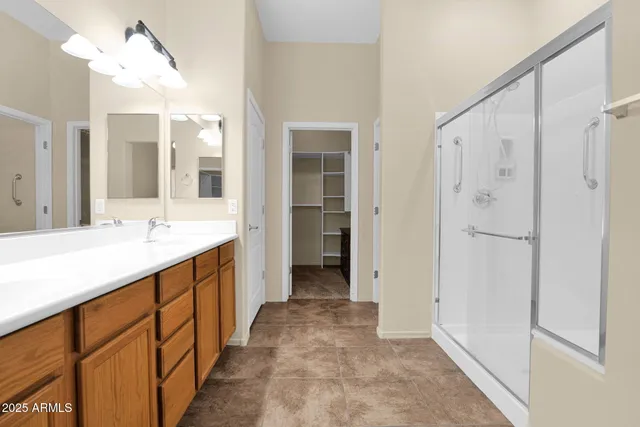 a bathroom with a double vanity sink and a mirror