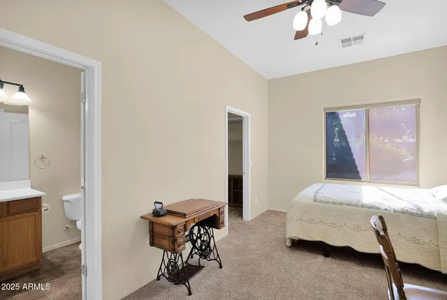 a view of a livingroom with workspace and a window