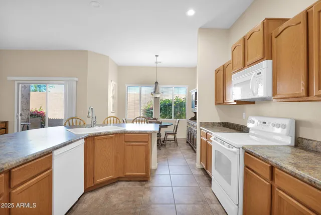 a view of a chairs and table in backyard