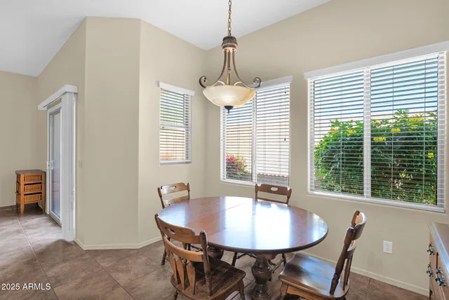 a dining room with furniture and window