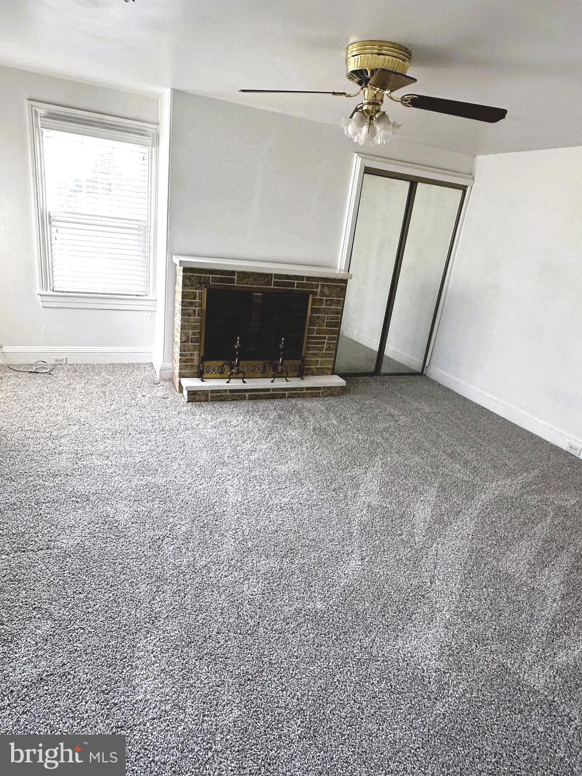 163 Klockner Road Trenton, NJ 08619 - Photo 12 of 22 an empty room with windows fireplace and a sink