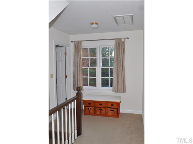 3833 Old Coach Road Raleigh, NC 27616 - Photo 15 of 24 Large landing at the top of the stairs with wide hallway to the three bedrooms.