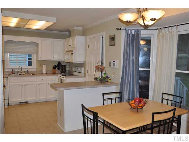 3833 Old Coach Road Raleigh, NC 27616 - Photo 4 of 24 Bright kitchen with lots of natural light through the bay window. New udated faucets and light fixtures.