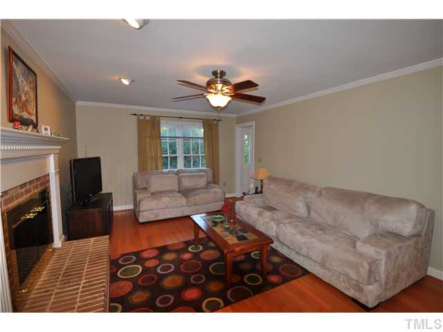 3833 Old Coach Road Raleigh, NC 27616 - Photo 8 of 24 Large living room with cozy fireplace and new hardwood floors.