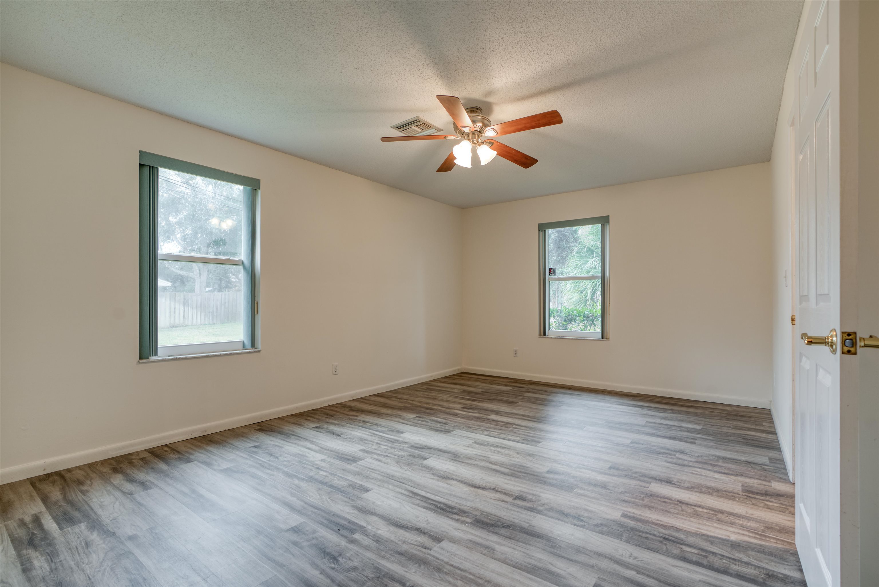 515 Gentian Road St. Augustine, FL 32086 - Photo 25 of 49 a view of empty room with wooden floor and fan