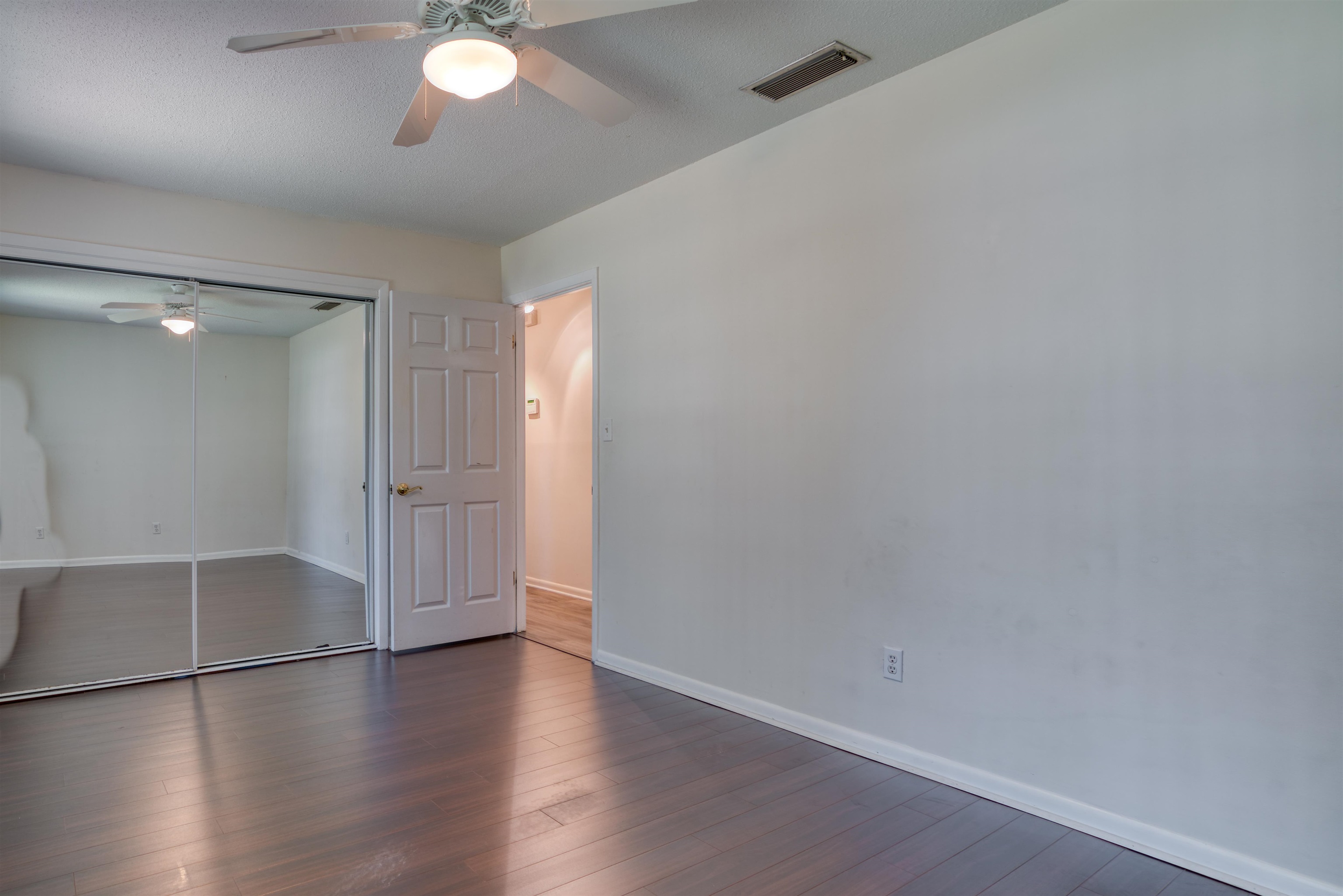 515 Gentian Road St. Augustine, FL 32086 - Photo 30 of 49 an empty room with wooden floor and windows