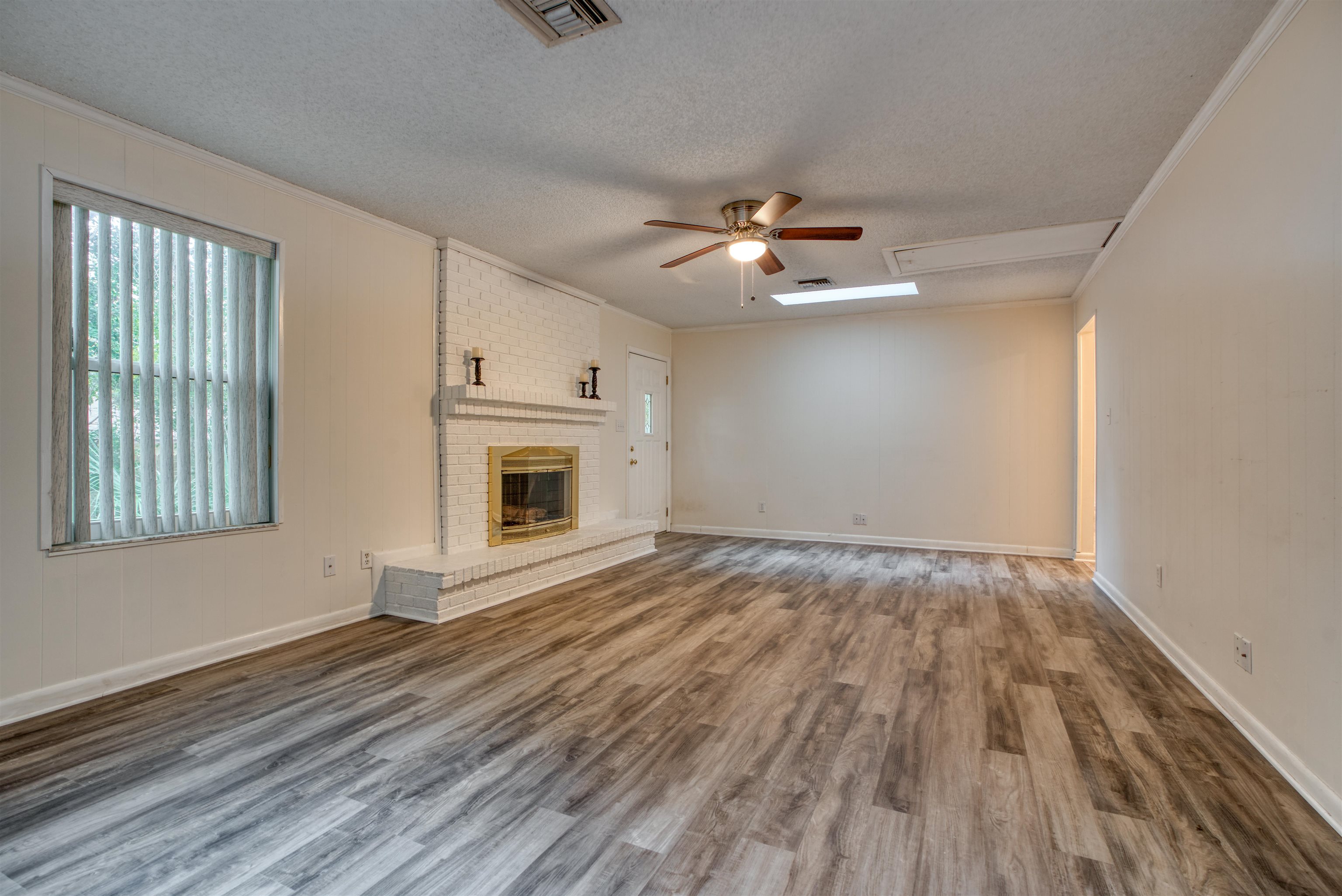 515 Gentian Road St. Augustine, FL 32086 - Photo 8 of 49 a view of an empty room with a fireplace and wooden floor