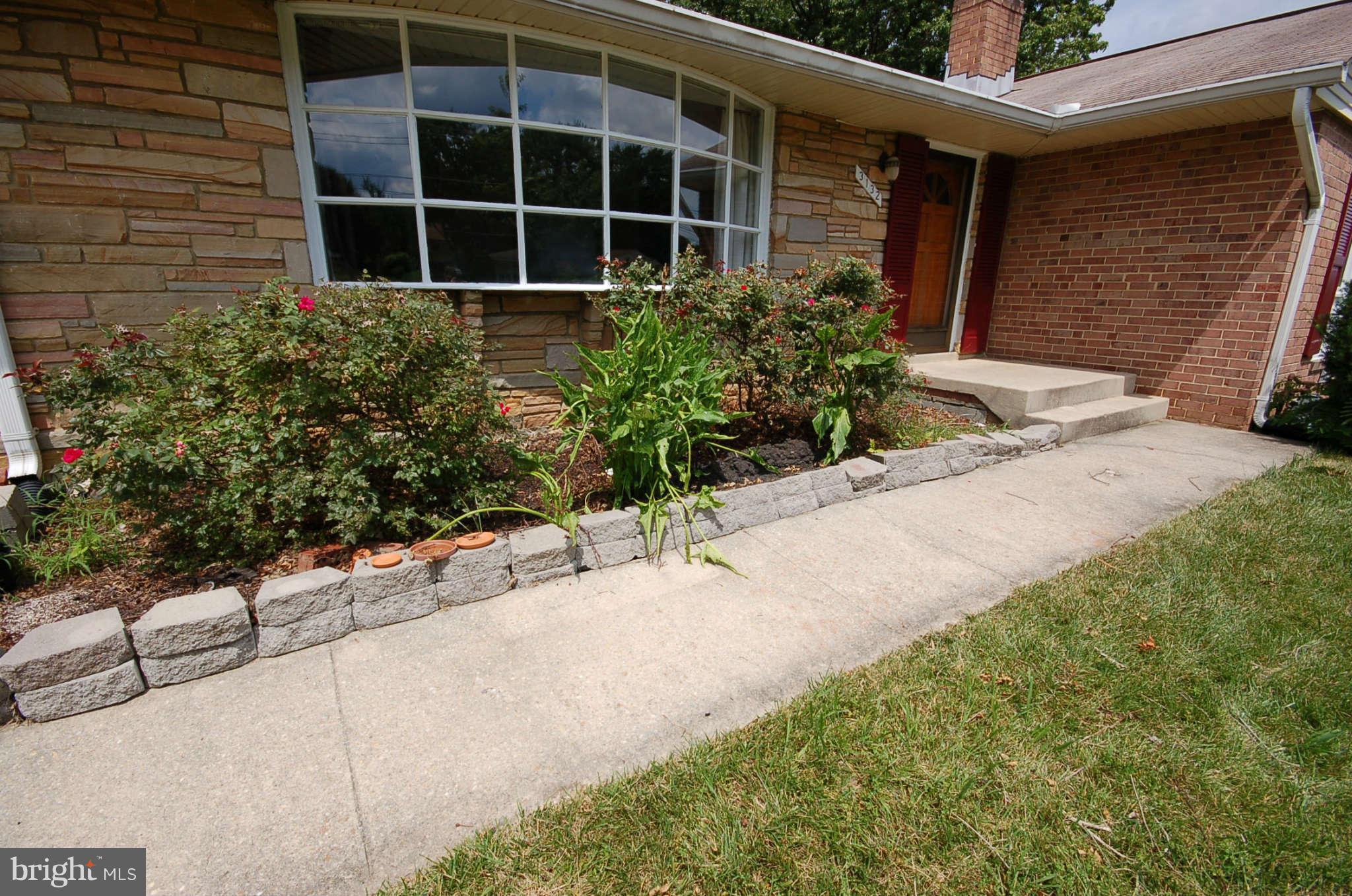 3132 Castleleigh Road Silver Spring, MD 20904 - Photo 2 of 25 a front view of a house with a yard and garage