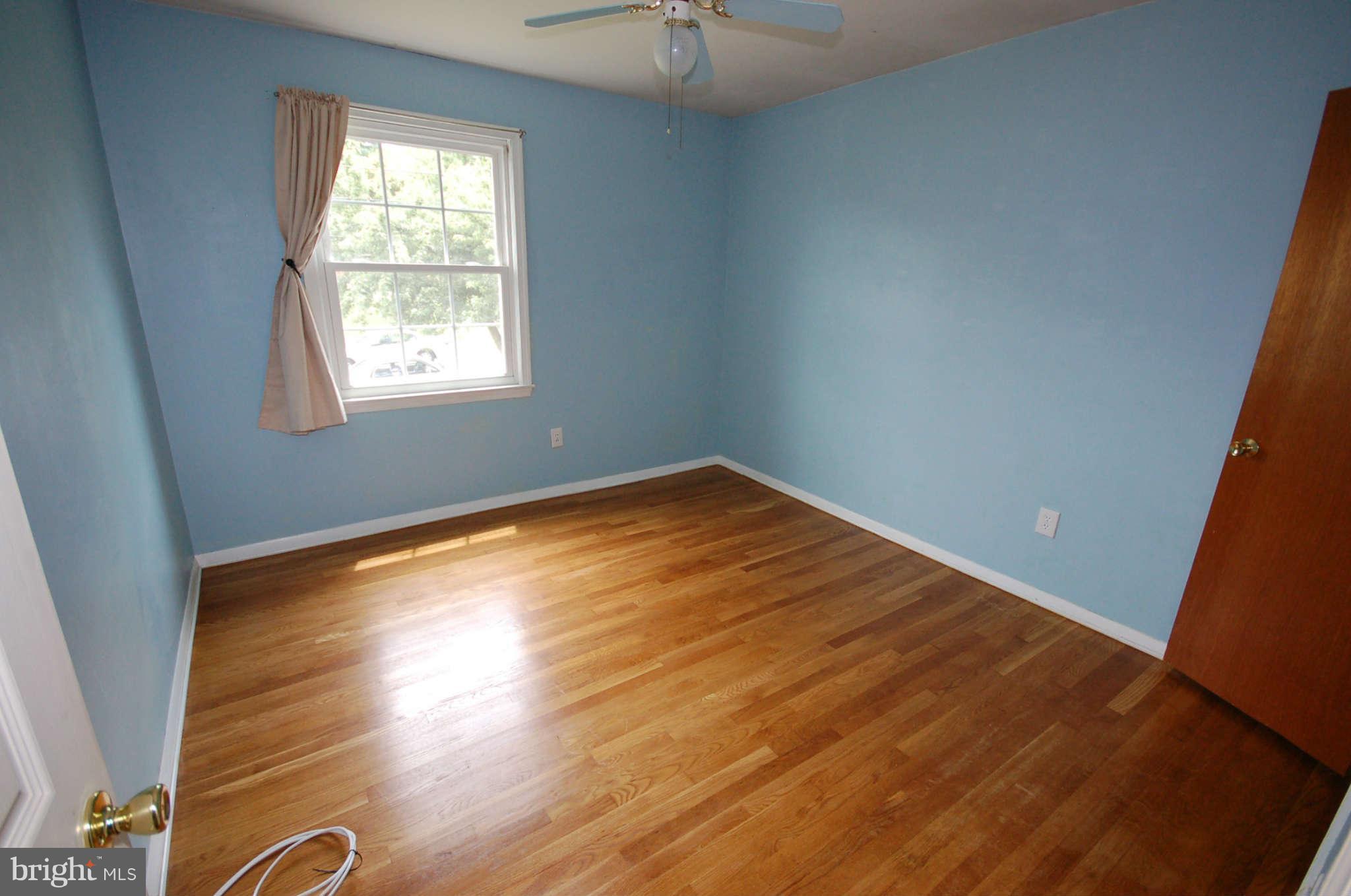 3132 Castleleigh Road Silver Spring, MD 20904 - Photo 12 of 25 an empty room with wooden floor and windows