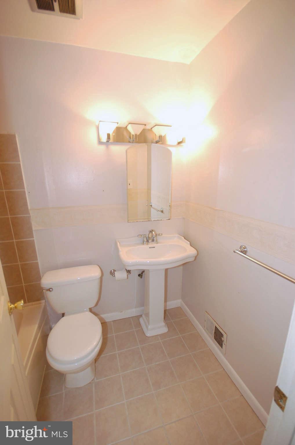 3132 Castleleigh Road Silver Spring, MD 20904 - Photo 13 of 25 a bathroom with a toilet sink and mirror