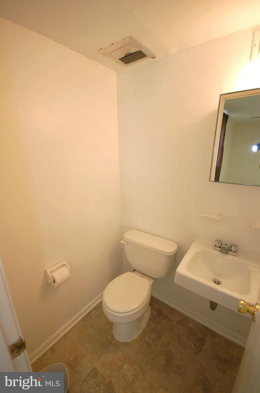 3132 Castleleigh Road Silver Spring, MD 20904 - Photo 17 of 25 a white toilet sitting next to a bathroom sink