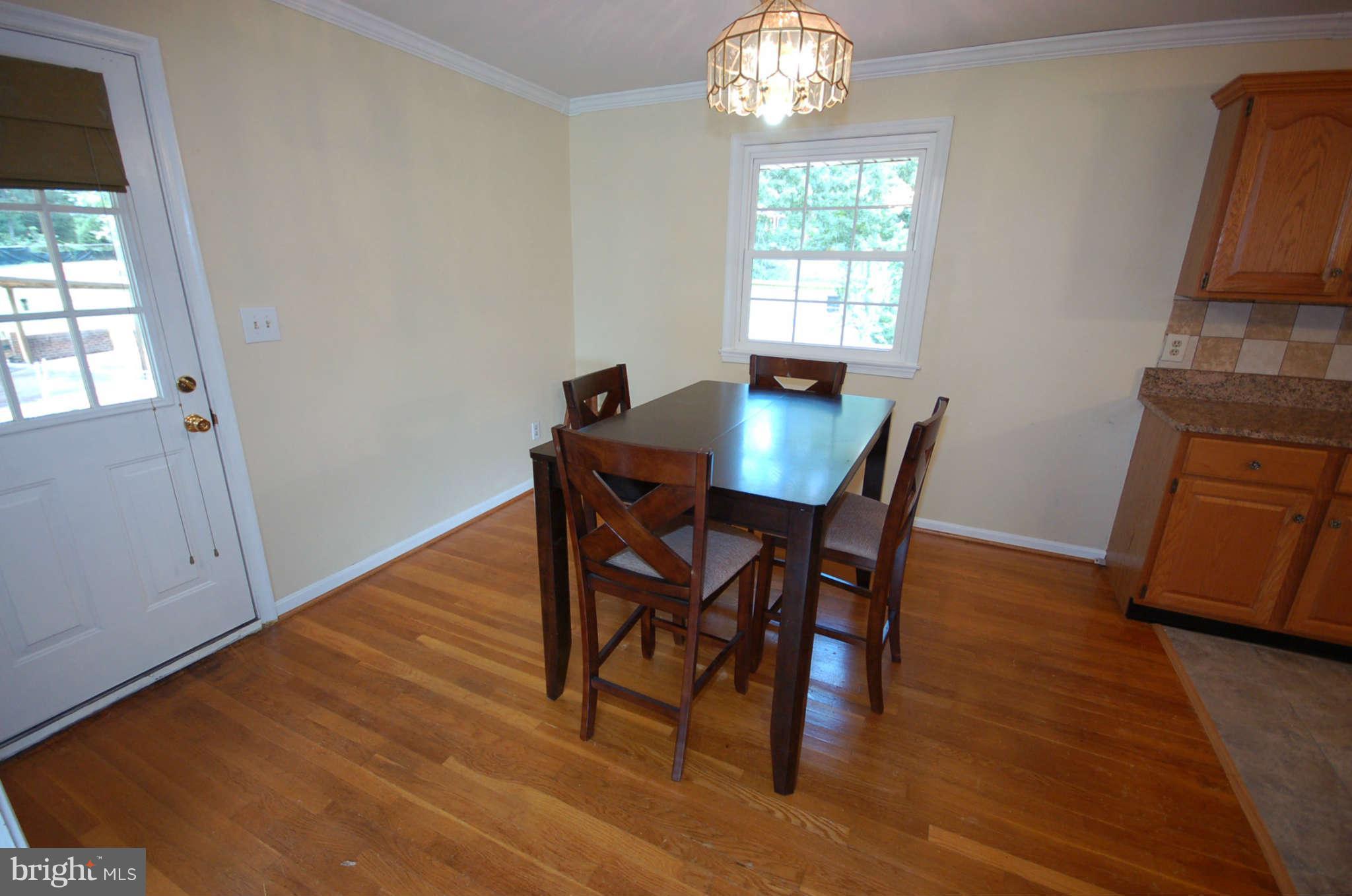 3132 Castleleigh Road Silver Spring, MD 20904 - Photo 5 of 25 a view of a dining room with furniture and wooden floor