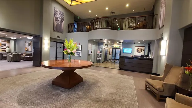 a lobby with furniture and a potted plant