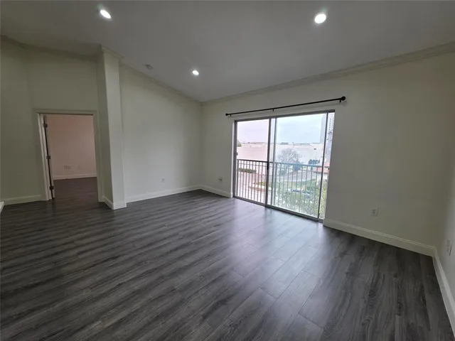a view of wooden floor and windows in a room