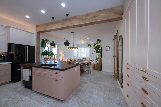 a kitchen with white cabinets and appliances