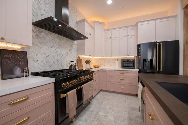 a kitchen with kitchen island granite countertop wooden cabinets and stainless steel appliances