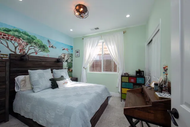 a bedroom with a large bed and a window