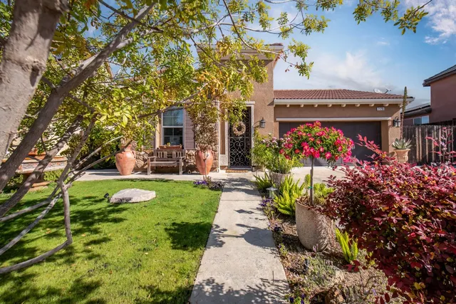 a front view of house with a garden