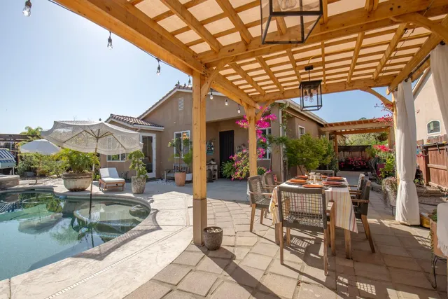 a backyard of a house with table and chairs
