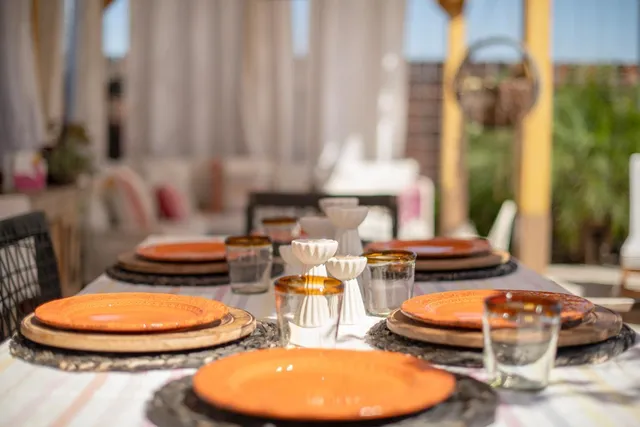 a view of a patio with table and chairs potted plants